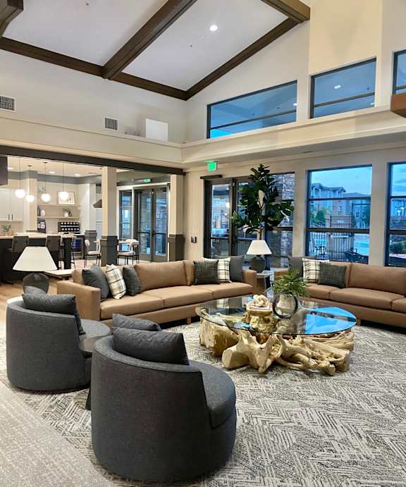A large room with a long couch and a coffee table in front of it.